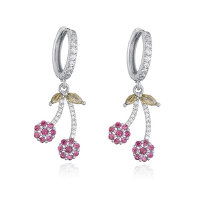 Macro view of cherry-shaped earrings with pink crystals and yellow stones on silver hoop
