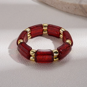 Detail of red glitter resin blocks and gold spacers on bohemian stretch bracelet