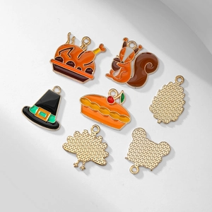 Enamel Thanksgiving charm set with turkey, squirrel and pie motifs on white background
