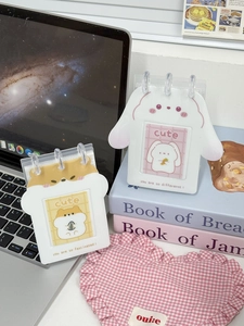 Close-up of cute acrylic standing photocard holder with transparent binder rings for desk