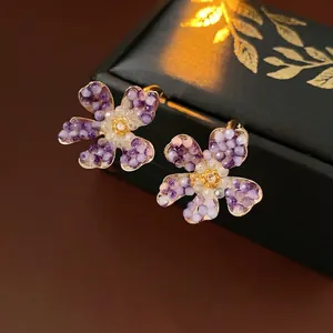 Vintage C-shaped floral earrings with purple beads and central champagne crystal detail