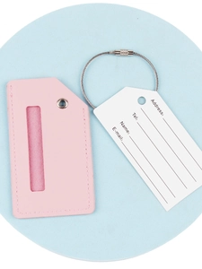 Pink PU leather luggage tag with steel wire loop and information card on blue base