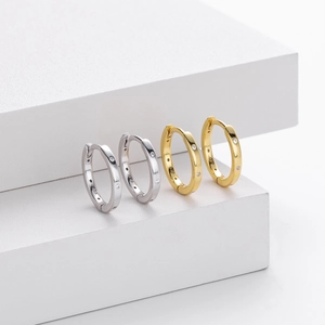 Detailed view of silver and gold S925 sterling silver hoop earrings with inset diamonds