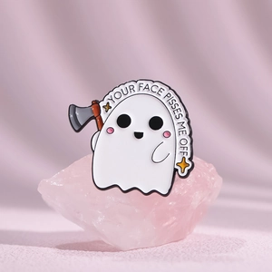 Macro detail of cartoon ghost enamel pin with Your Face Pisses Me Off text on pink crystal