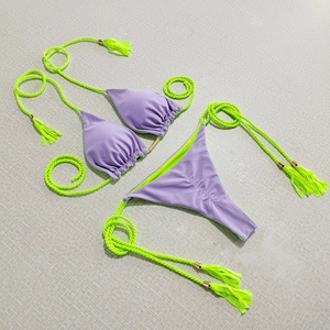 Two-piece bikini set in purple and neon green with woven ties and tassel details