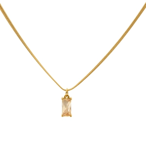 Macro detail of rectangle champagne zircon pendant on gold snake chain necklace