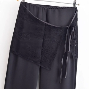 Pantalon noir pour femme avec superposition de dentelle et ceinture en satin