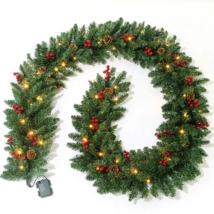 Macro detail of 9FT Christmas garland with pine cones, red berries and warm LED lights