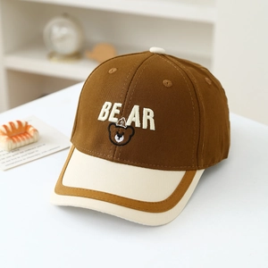 Detailed close-up of brown canvas kids baseball cap with BEAR embroidery and cartoon bear