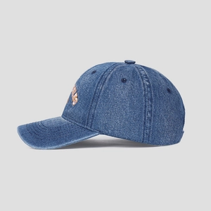 Detail of embroidered ANGELES text on dark blue washed denim baseball cap texture