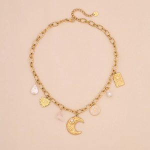Detail view of gold stainless steel necklace with star, moon, and pearl charms