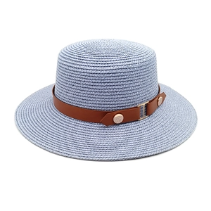 Detail of light blue woven straw hat with brown leather band and gold metal buckle