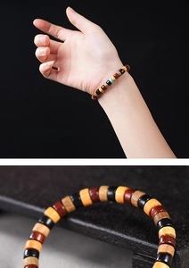 Macro shot of colorful wooden pill-shaped beads with a green accent on an elastic bracelet