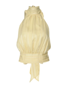 Detail of light yellow halter top featuring silky striped texture and elegant back tie