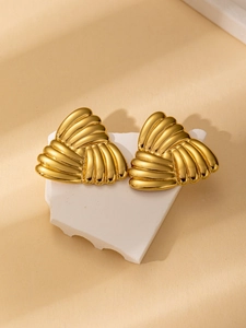 Detailed close-up of 18K gold plated titanium steel earrings with a triple knot design