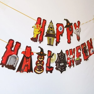 Close-up of Happy Halloween banner with pumpkins and ghosts on a white wall