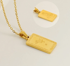 Detail showing gold stainless steel zodiac monkey pendant and Buddha patron engraving