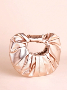 Macro detail of rose gold pleated cloud bag showing metallic texture and crescent shape