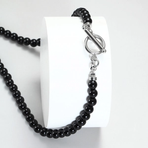 Men's tiger eye beaded necklace with silver OT toggle clasp on a white display