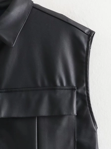 Detail of faux leather vest showing collar stitching and utility cargo pocket textures