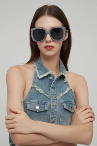Close-up of oversized square sunglasses with full rhinestone frame on a female model