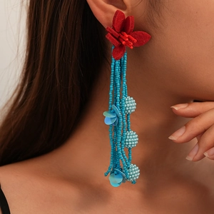 Handmade red fabric flower earrings with long turquoise beaded tassels in ethnic style