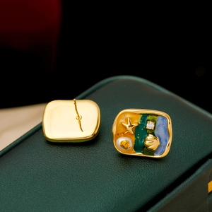 Vintage starfish and pearl enamel stud earrings on luxury green velvet jewelry box