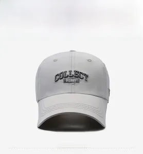Detailed close-up of light grey quick-dry baseball cap with black letter embroidery