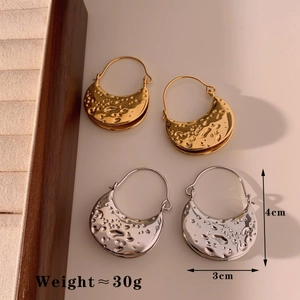Detail of textured hammer-finish half-moon earrings in gold and silver with size labels