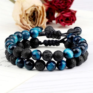 Detail of 8mm blue tiger eye and black lava stone beaded bracelets with adjustable cord