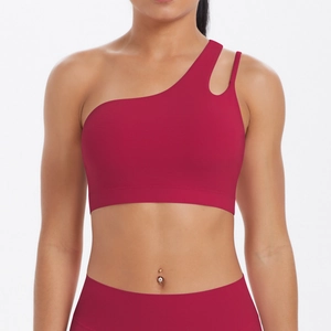 Detail of burgundy sports bra with asymmetrical one-shoulder design and cutout strap