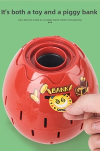 Macro shot showing person inserting a toy coin into the red spherical pirate barrel bank