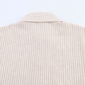 Detailed macro view of the striped linen shirt back collar with horizontal patterns