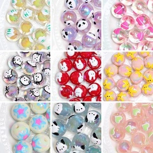 Macro shot of colorful 16mm hand-painted beads with cartoon patterns for DIY jewelry
