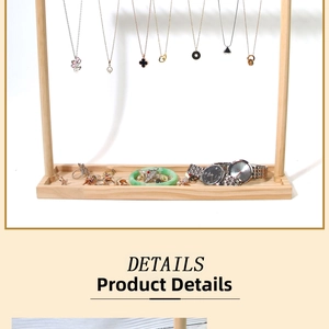 Detail of wooden jewelry display stand featuring multi-layer hanging bars and a base tray
