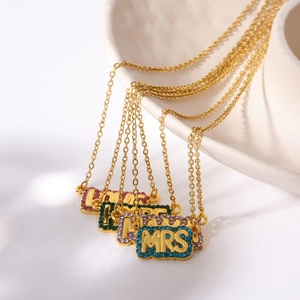 Detailed view of gold necklaces with colorful rhinestone LOVE and HOPE pendants