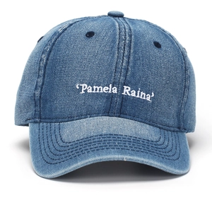 Close-up of white letter embroidery on blue washed denim vintage baseball cap