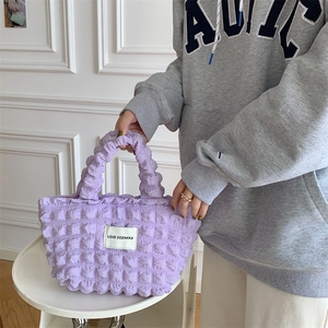 Detail of purple bubble texture canvas handbag with LOVE SOZAKKA logo label