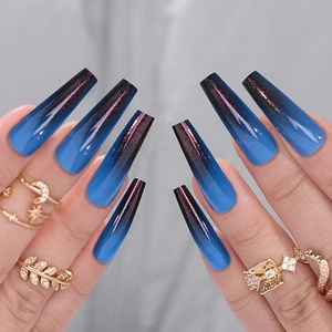 Close-up of long coffin fake nails with blue gradient color and fine glitter effect