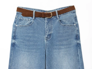 Detail of light blue denim culottes with brown suede belt and metal button fly