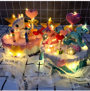 Detail view of unicorn music box with warm LED string lights and festive ribbons