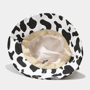 Detail view of the cow print bucket hat interior with lining and adjustable drawstring