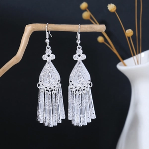 Detailed view of vintage silver alloy tassel earrings with hollow geometric patterns
