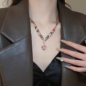 Close-up of heart-shaped pink zircon pendant necklace with multi-colored gemstones