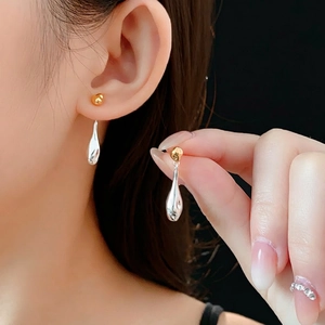 Minimalist two-tone gold round stud and silver teardrop tassel earrings for women