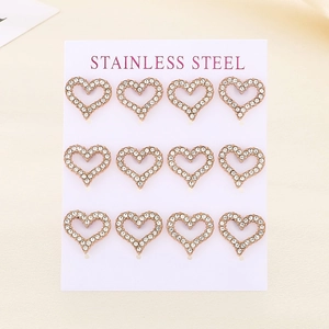 Macro view of twelve rose gold stainless steel heart stud earrings with white rhinestones
