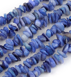 Close-up of blue natural shell gravel beads for DIY jewelry making and necklace crafts