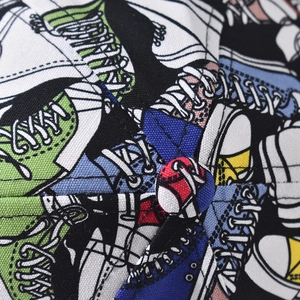 Macro shot of durable canvas baseball cap with colorful cartoon sneaker print and top button