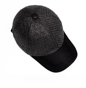 Top view of black woven straw baseball cap showing detailed texture and crown button