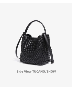 Close-up of black hand-woven leather bucket bag with reinforced handle and shoulder strap